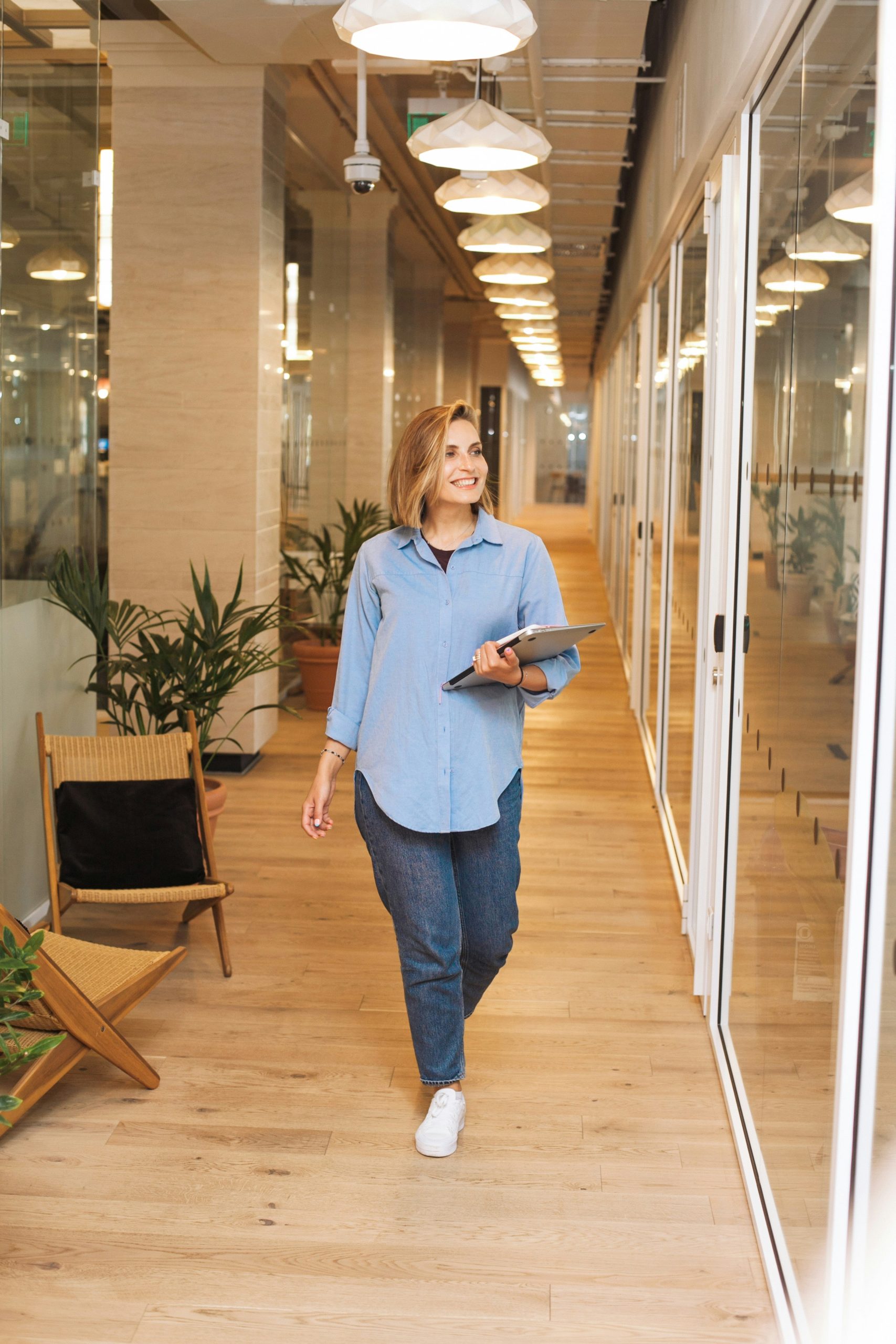 Woman walking with a tablet in hand